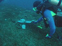 Bob inspecting artifacts removed from the wreck and placed on the hull for divers to see...