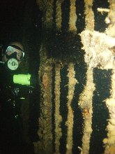 Mike inspects a railing dividing two sections of Taiei Maru's interior...