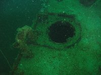 Some sort of huge porthole or manhole cover on the edge of the ship's deck...
